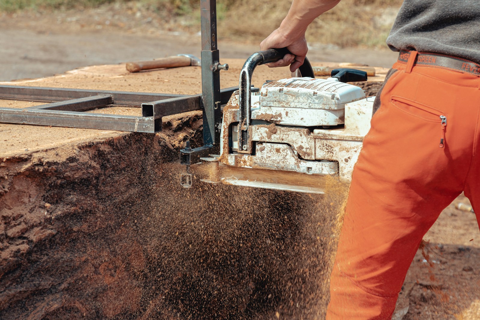 a man is using a machine to remove dirt from the ground